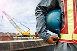 	man holding a blue construction hat