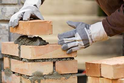 	person laying bricks