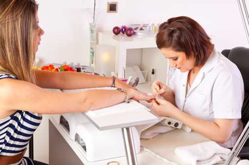 	woman painting another womans nails