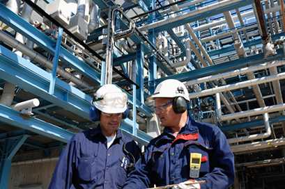 men in white hat at a manufacture plant