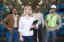 	wman with 3 men in a manufacture plant