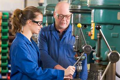 	woman and man drilling in a manufacture plant