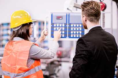 	woman and man in a manufacture plant