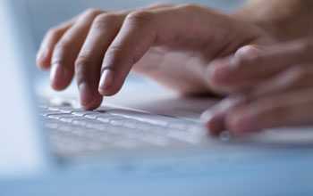 Close-up of a laptop keyboard as somebody types