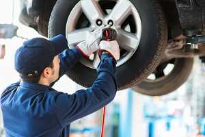 Auto mechanic working on a  car