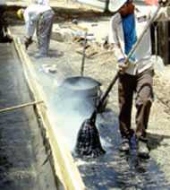 	applying hot asphalt to a roof