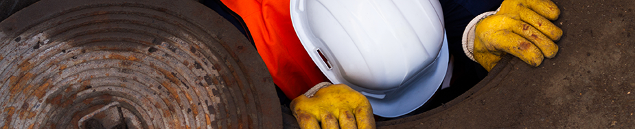 	worker climbing into manhole