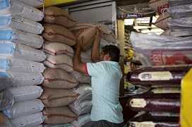 man placing large sack overhead