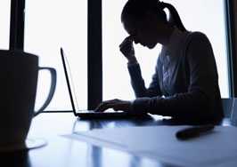 	Woman in front of laptop resting her eyes.