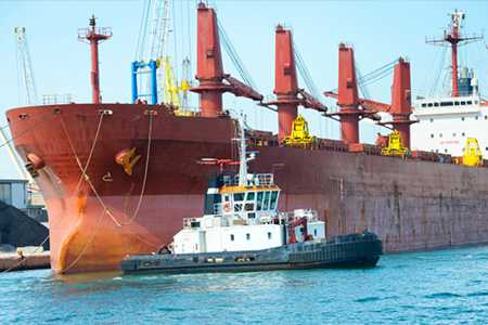 	Cargo ship and tug boat.