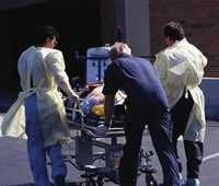 Medical Staff wheeling in patient on a stretcher