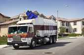 	Front view of garbage bin being loaded into truck