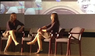 Two women chatting on a stage