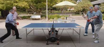 Two men playing table tennis