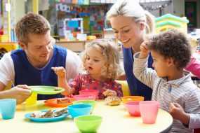 Photo: Children eating while adults supervise