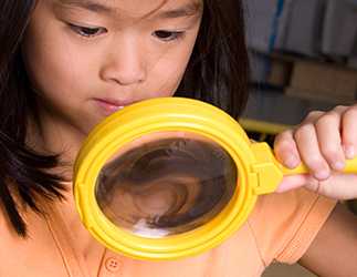 Little girl with magnifying glass