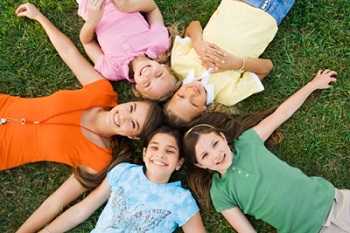 Children laying in a circle on the ground