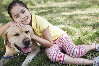 A girl hugging her pet dog