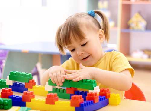 Little girl playing with Legos