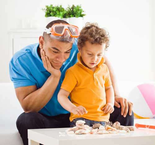 Dad and son looking at seashells