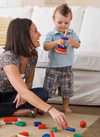 Mom and son playing with blocks on the floor