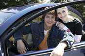 photo: boy and girl by a car