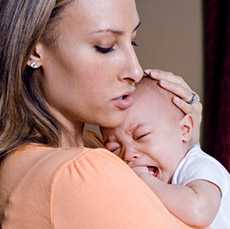 Mom holding crying baby