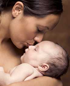 Mother kissing infant