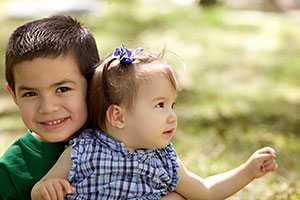 Toddler holding baby