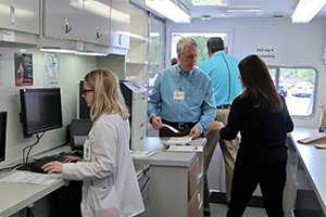 Mobile pharmacy staff prepare naloxone kits for dispensing. 