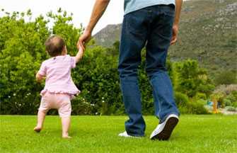 father and daughter walking in field