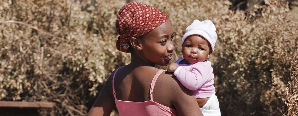 Image of a young woman holding her baby