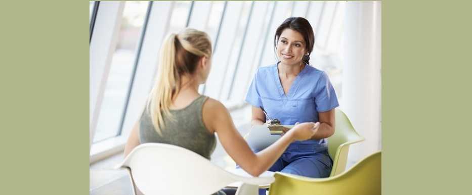 woman speaking with her nurse