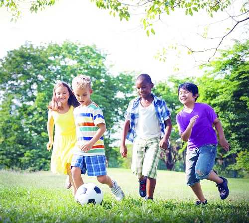 Group of children playing soccer