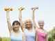 Three older women lifting dumbbells