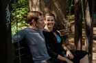 Man and woman sitting on a bench iin a park