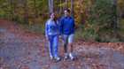 Man and woman holding hands in park