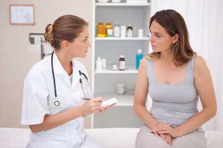 Woman talking to doctor.