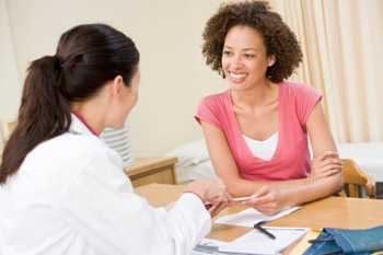 Woman talking with her doctor about medication use