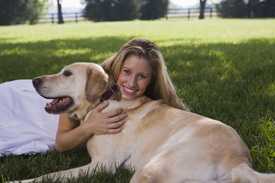 Woman hugging a dog on the ground