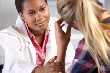 Photo of a clinician and her patient.