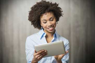 woman looking at tablet