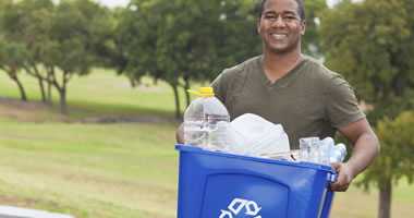 man holding recycling bin