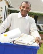 Man holding a recycling bin