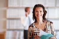 Healthy woman carrying papers