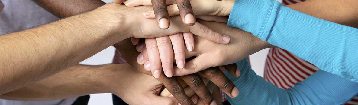 Image of a group of people piling up hands on top of hands: Promoting Science-Based Approaches to Teen Pregnancy Prevention Using Getting to Outcomes