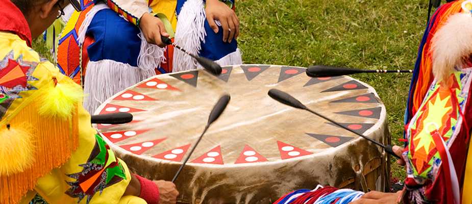 Multiple people playing a drum