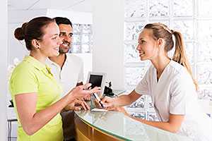 smiling nurse talking with young couple