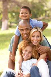 Happy family sitting outside.