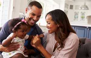 Father, mother and child reading newspaper